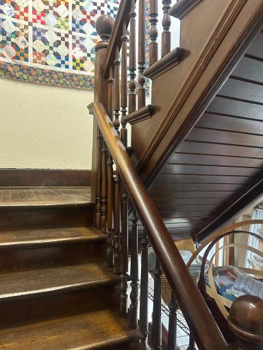 IN back of the main level is a door leading to the basement and this back foyer with steel door to east side of building for exit. Also solid stairwell leading up to 2nd level.
