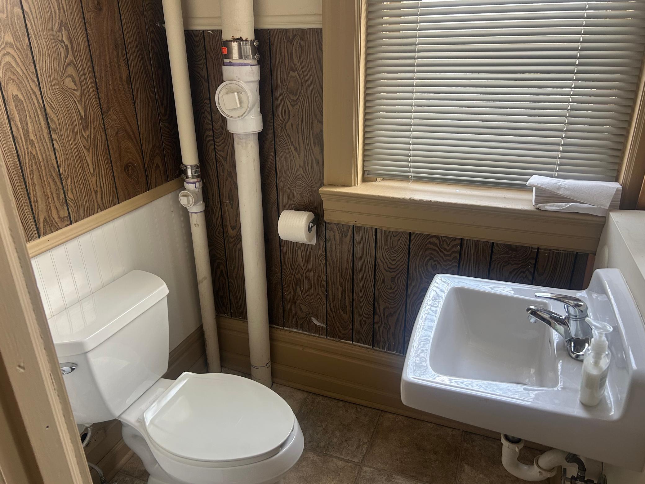 Upper level 1/2 bath. As you can see building has updated PVC.
