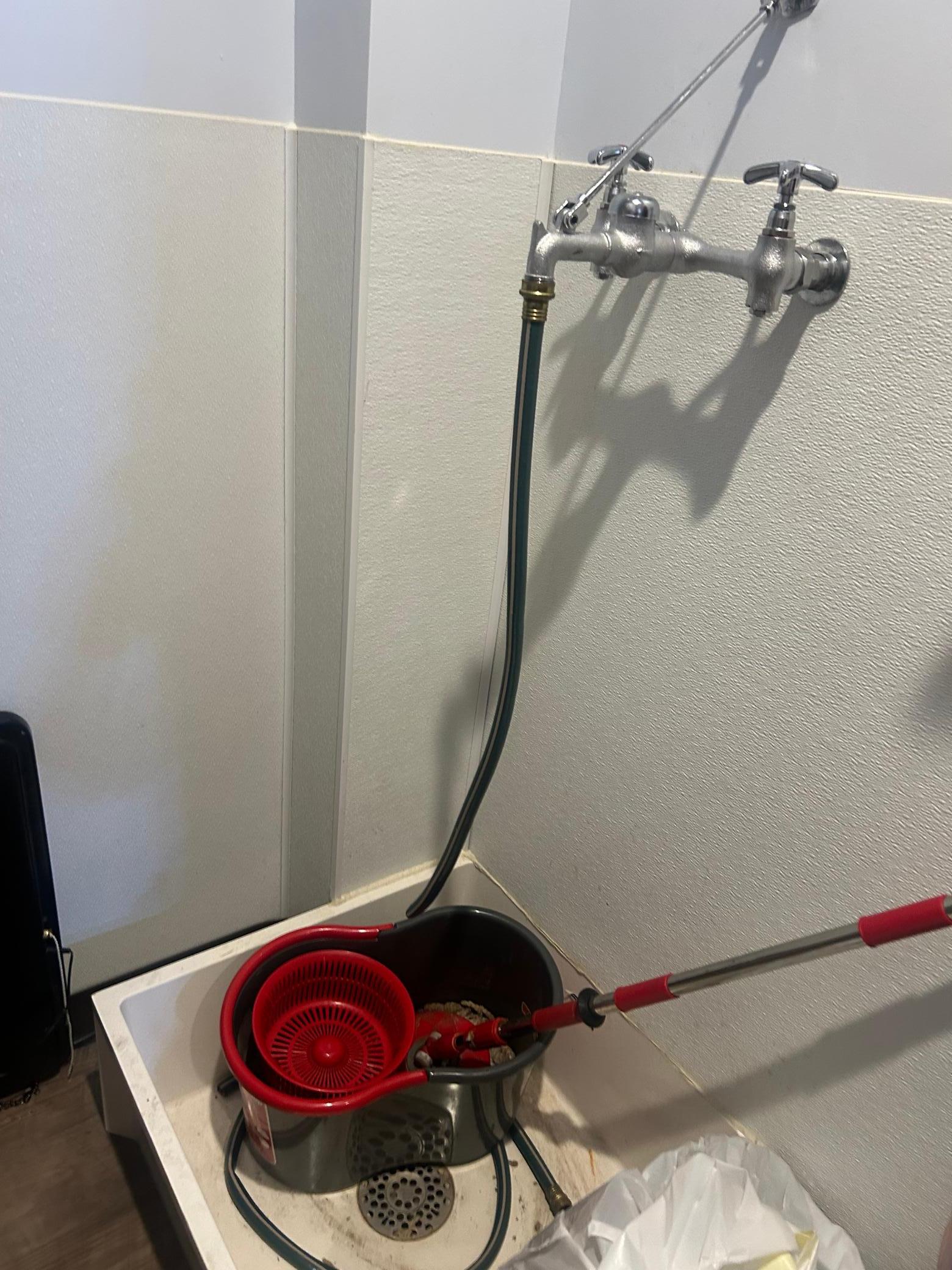 Main level storage room includes a floor soak tub with drain.