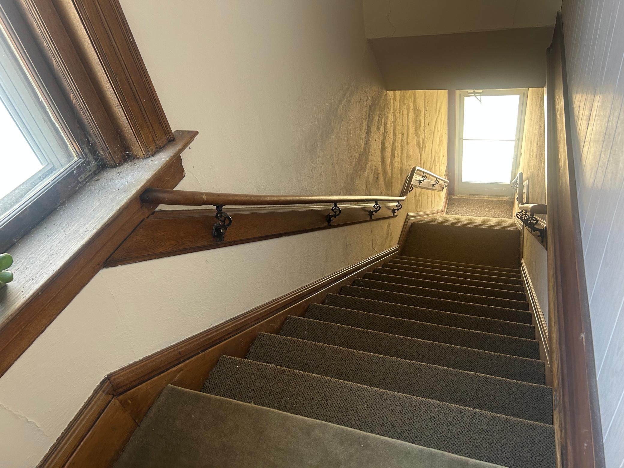 This is the 2nd full stairwell leading up to the upper level with street entrance.