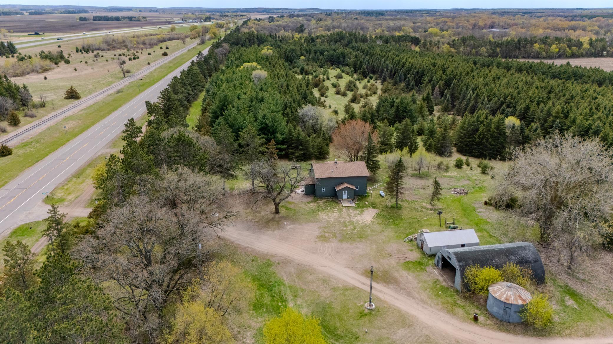 Aerial view of home and outbuildings