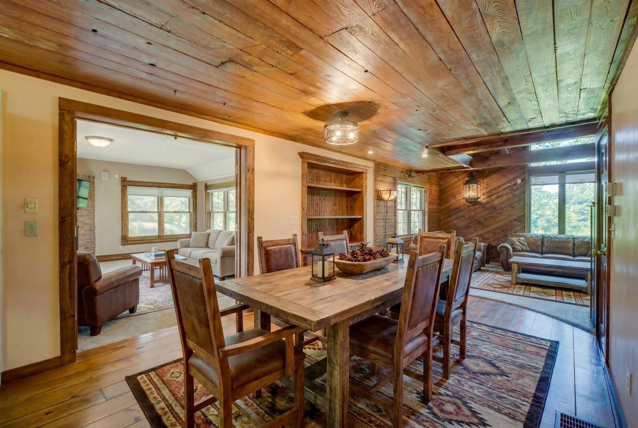 Warm wood floors, rich woodwork, and a sun-filled living room create an inviting atmosphere. (virtually staged)