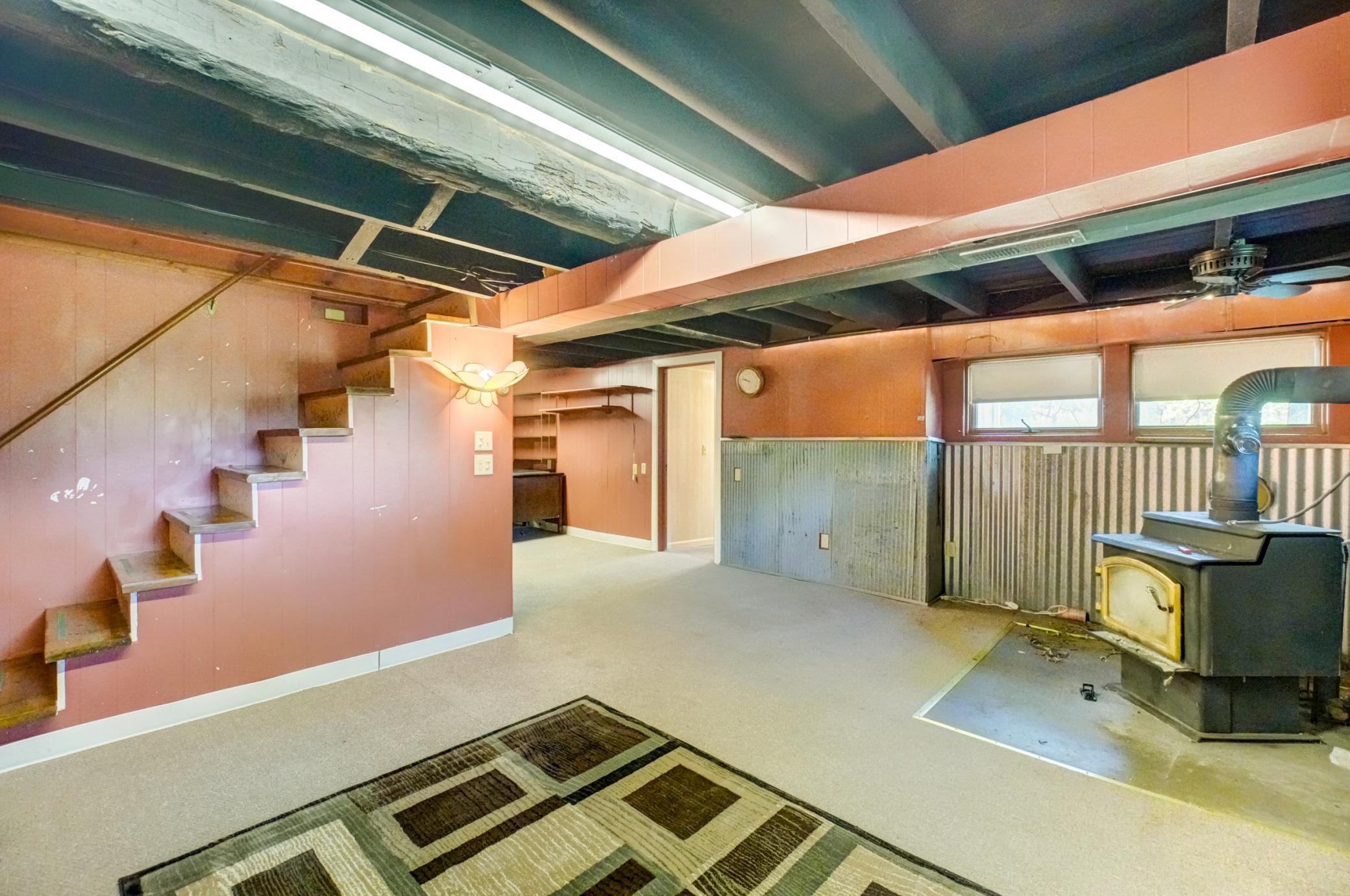 A finished lower-level family room with a wood-burning stove provides even more room to relax.