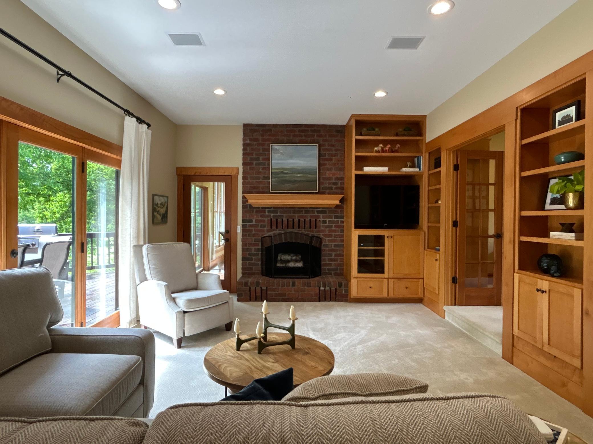 The Family Room offers an inviting wood burning fireplace and custom built-ins.