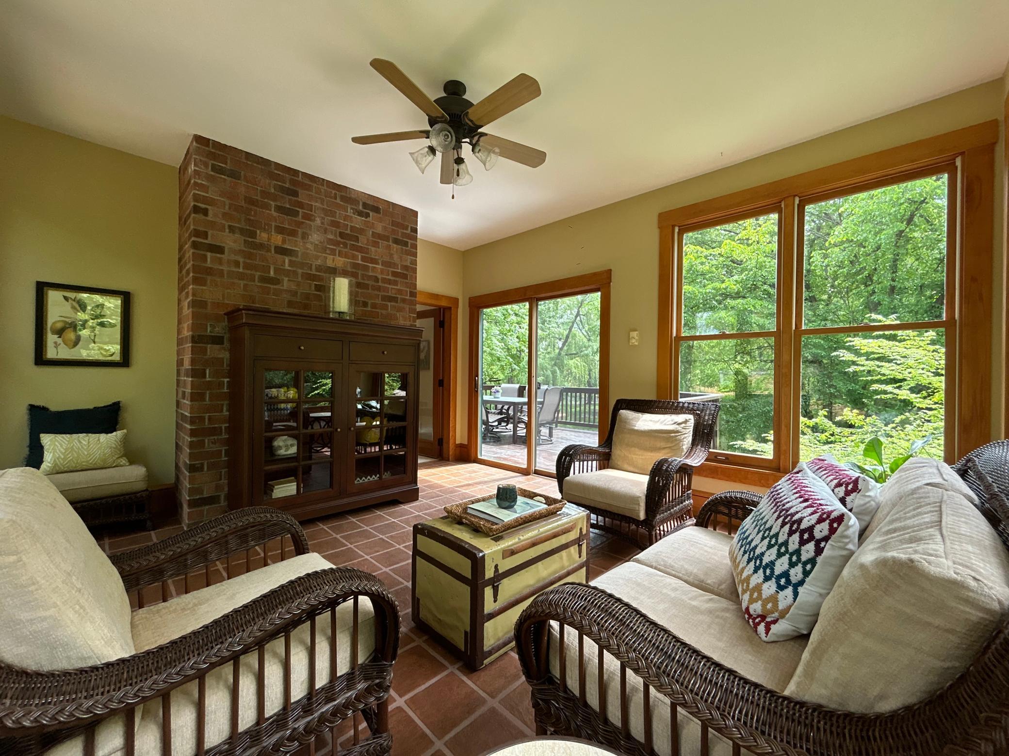 The Sun Room is sure to become a favorite gathering place with floor-to-ceiling windows and towering trees all around.