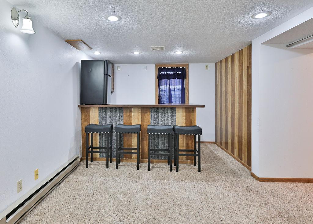 Wet bar & Egress window behind, Wood accent wall.