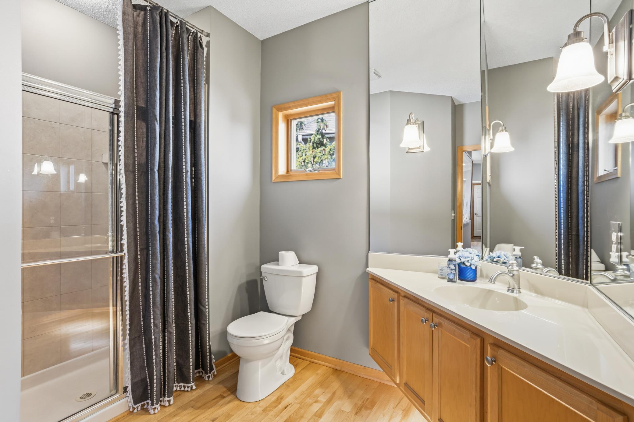The hall bath on the main level is a 3/4. This is ideal for the person using the second bedroom! Notice the cool lights under the elevated vanity.
