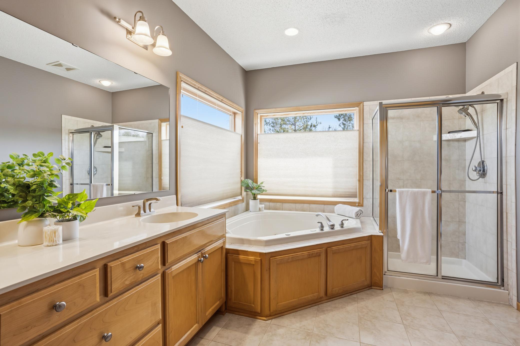 Private Primary four piece bath is bright and light with large windows offering top down blinds for privacy