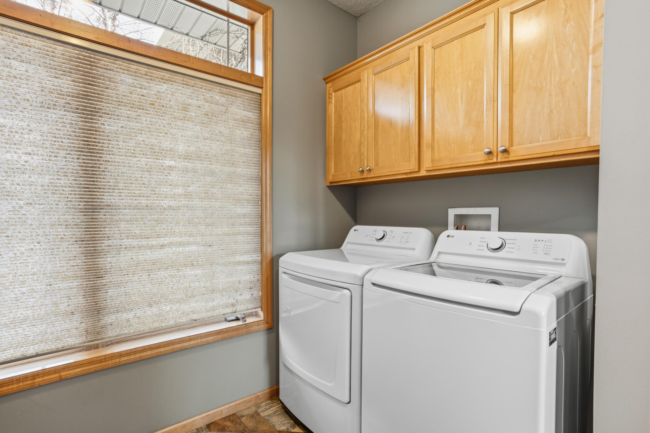 Abundant storage and folding space in this main level laundry room.