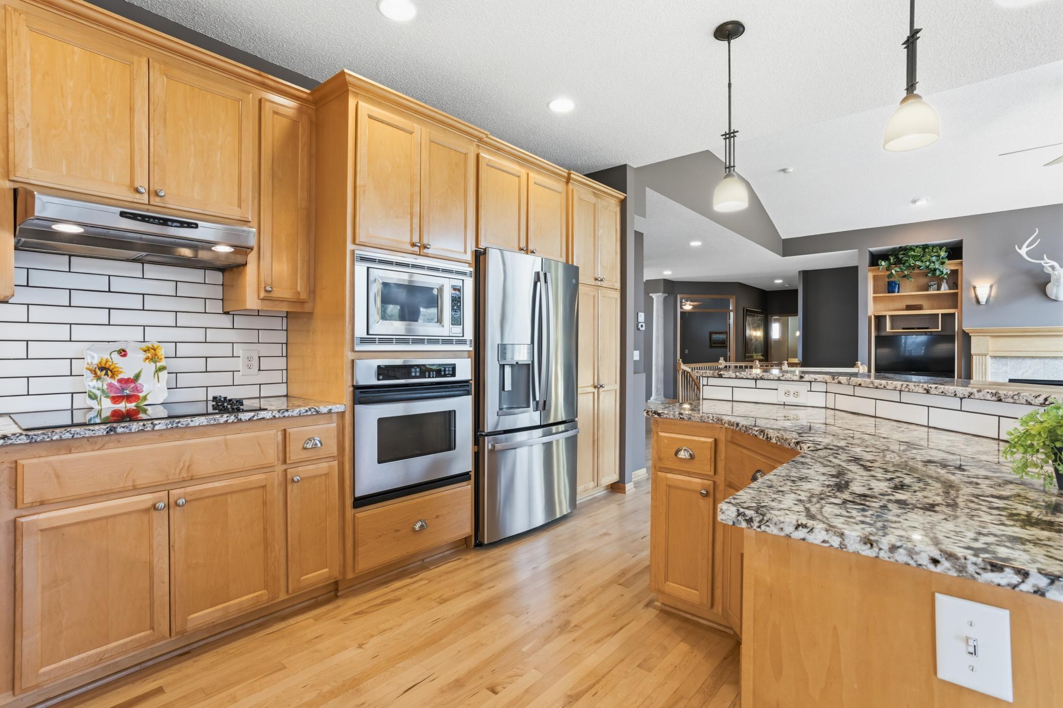 A brand new cooktop completes this well appointed kitchen while the open-concept layout flows seamlessly into the dining and living areas.
