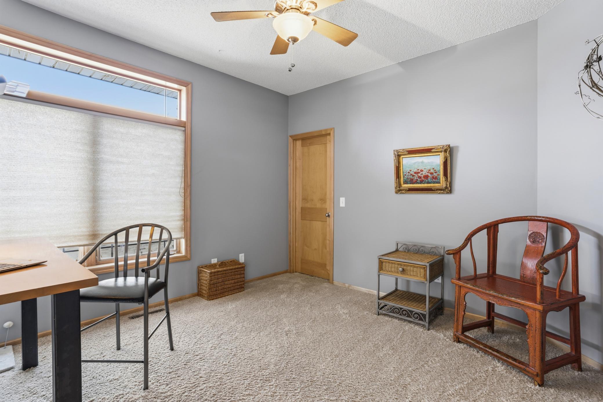 The main-level second bedroom is generously sized at 12x12, featuring a walk-in closet for ample storage. Conveniently located near a three-quarter bath, it’s perfect for family, guests, or a versatile home office space.