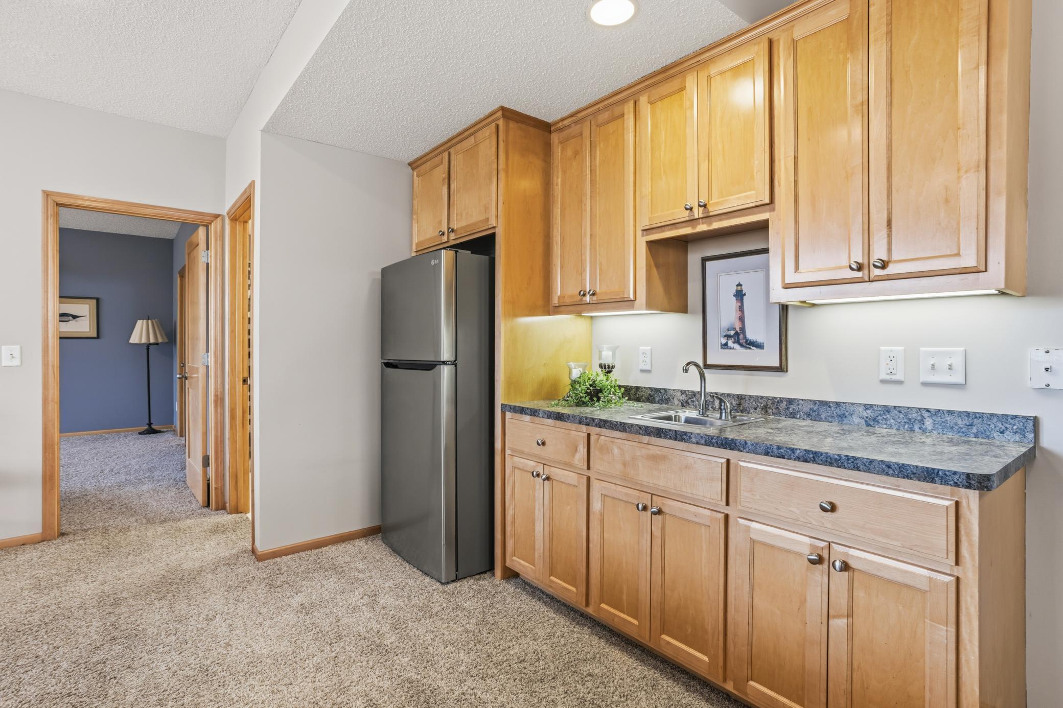 Wet bar in the lower level provides additional ample storage and convenience of access to drinks and snacks!