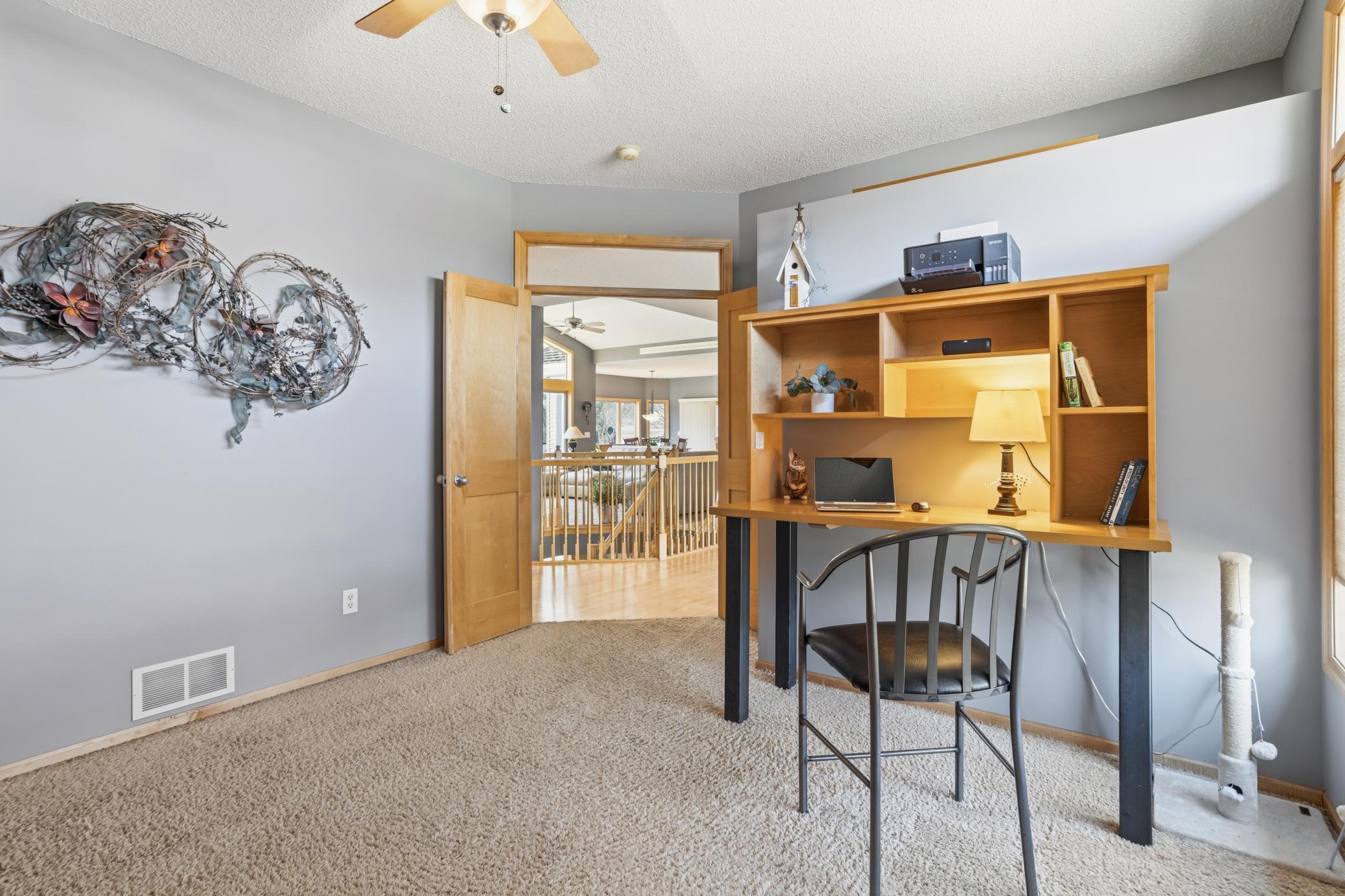 View from the second bedroom, currently being used as an office space through its elegant double doors into the home.