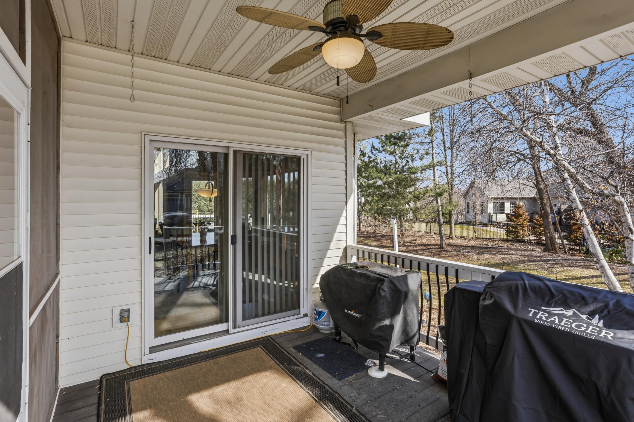 Step from the home or the screened porch onto the covered deck, also featuring a ceiling fan. This area provides easy access to both the back and side yards, and is the perfect convenient location for some grilling!