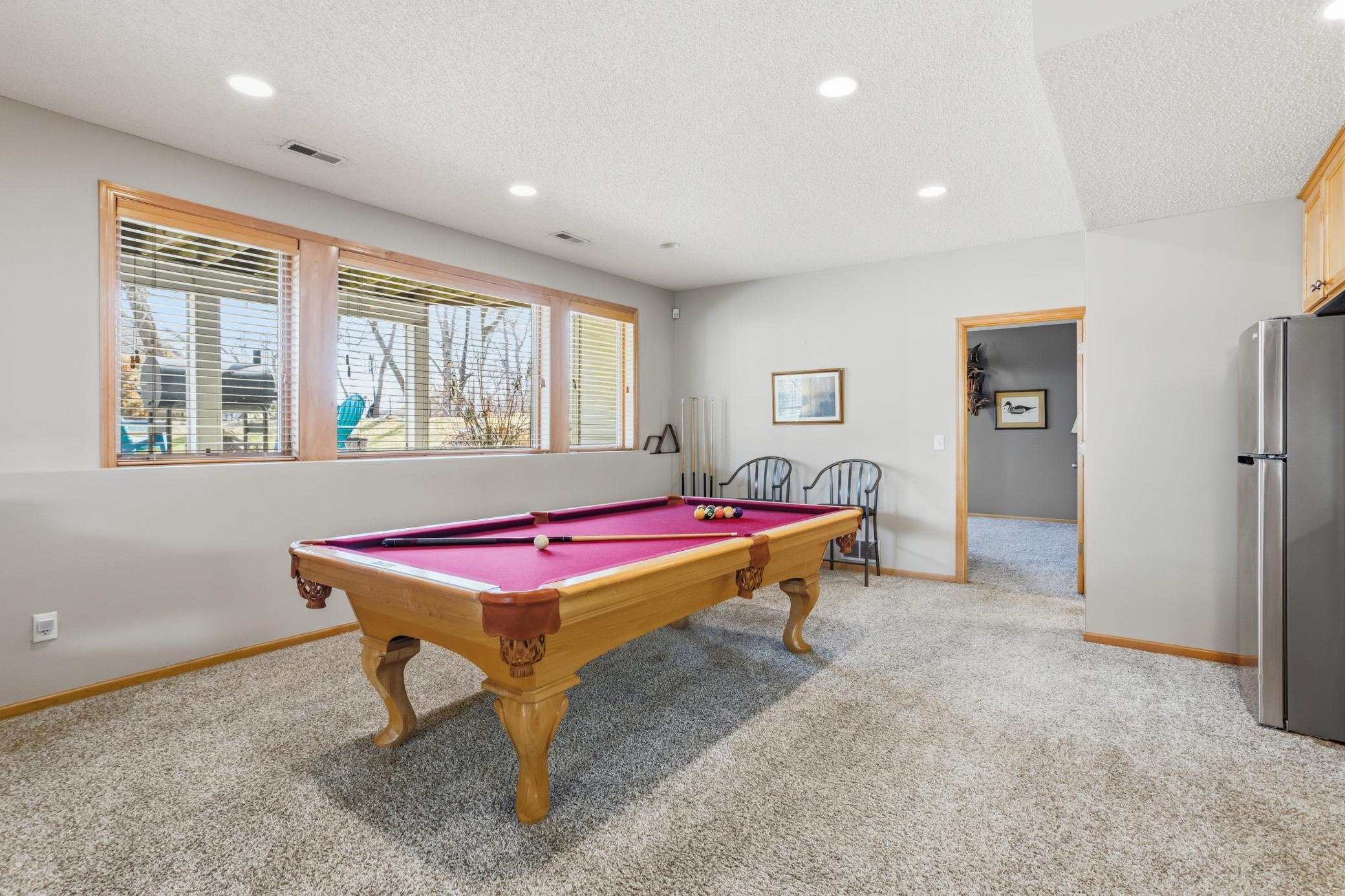 Recessed lighting and big beautiful windows create a bright and inviting space.