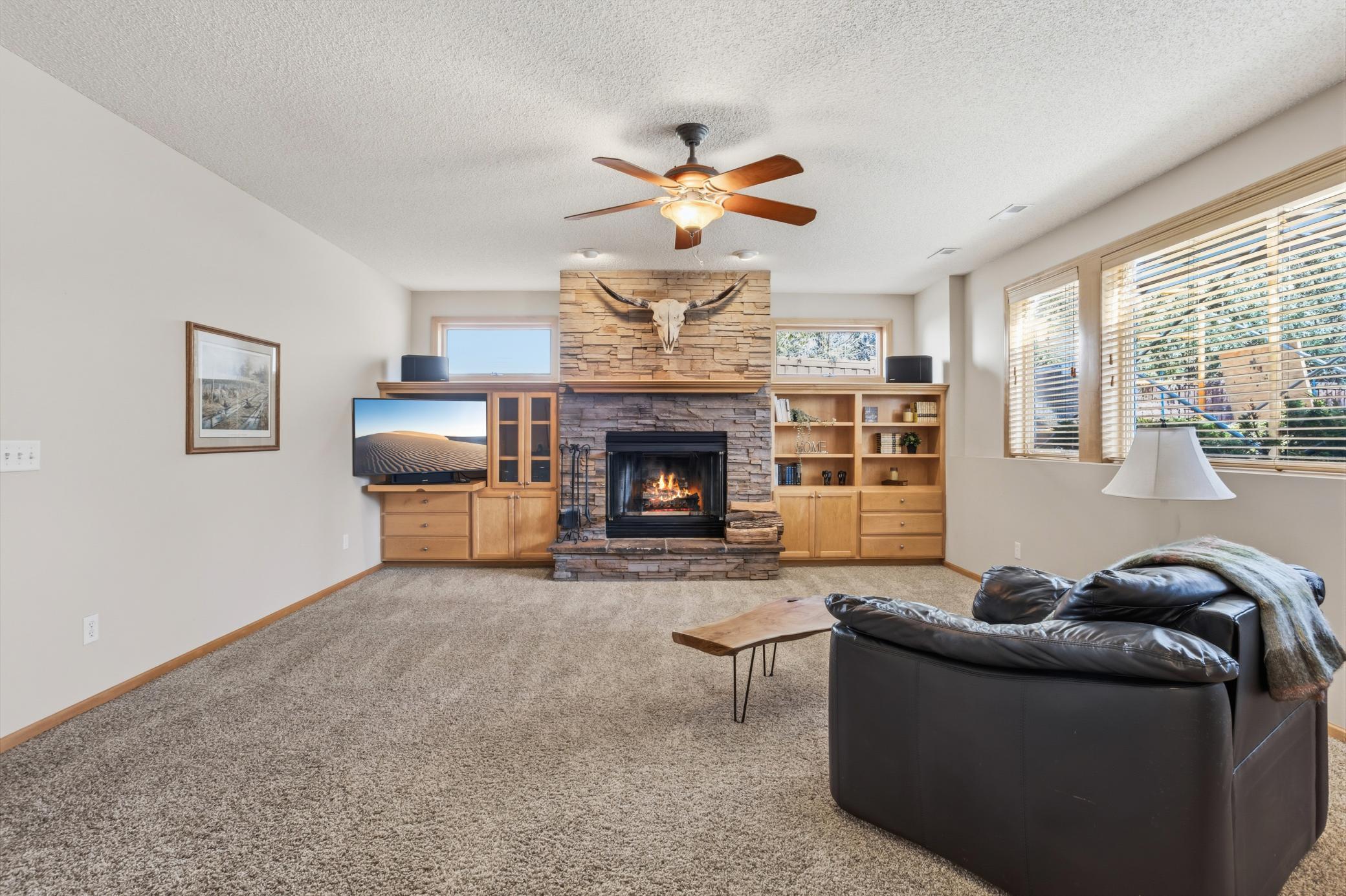 Welcome to the lower level of this stunning custom rambler! The fireplace in the lower level is wood burning, creating an authentic cozy vibe.