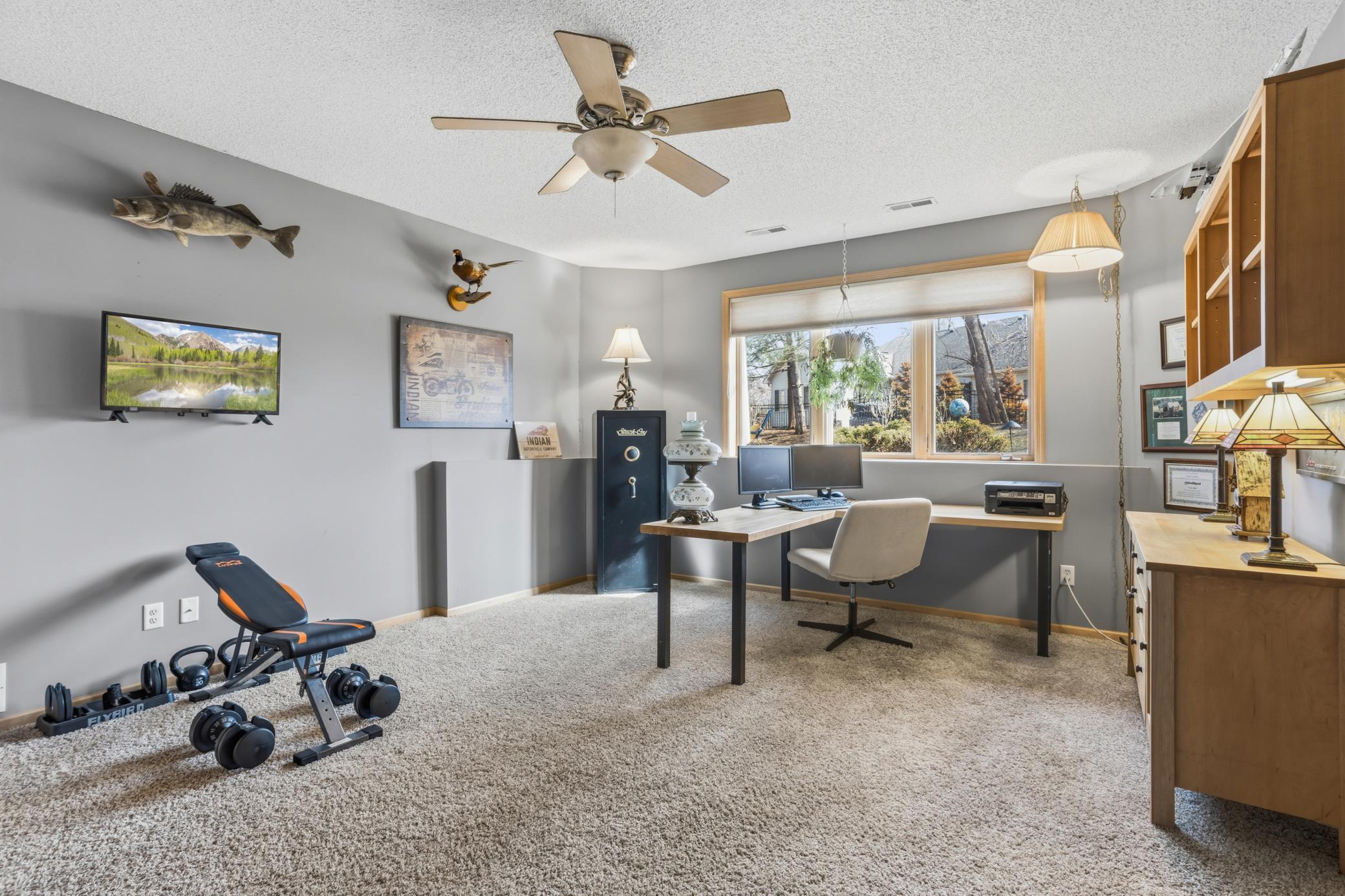 In addition to the recessed lighting, this oversized bedroom also affers a ceiling fan.