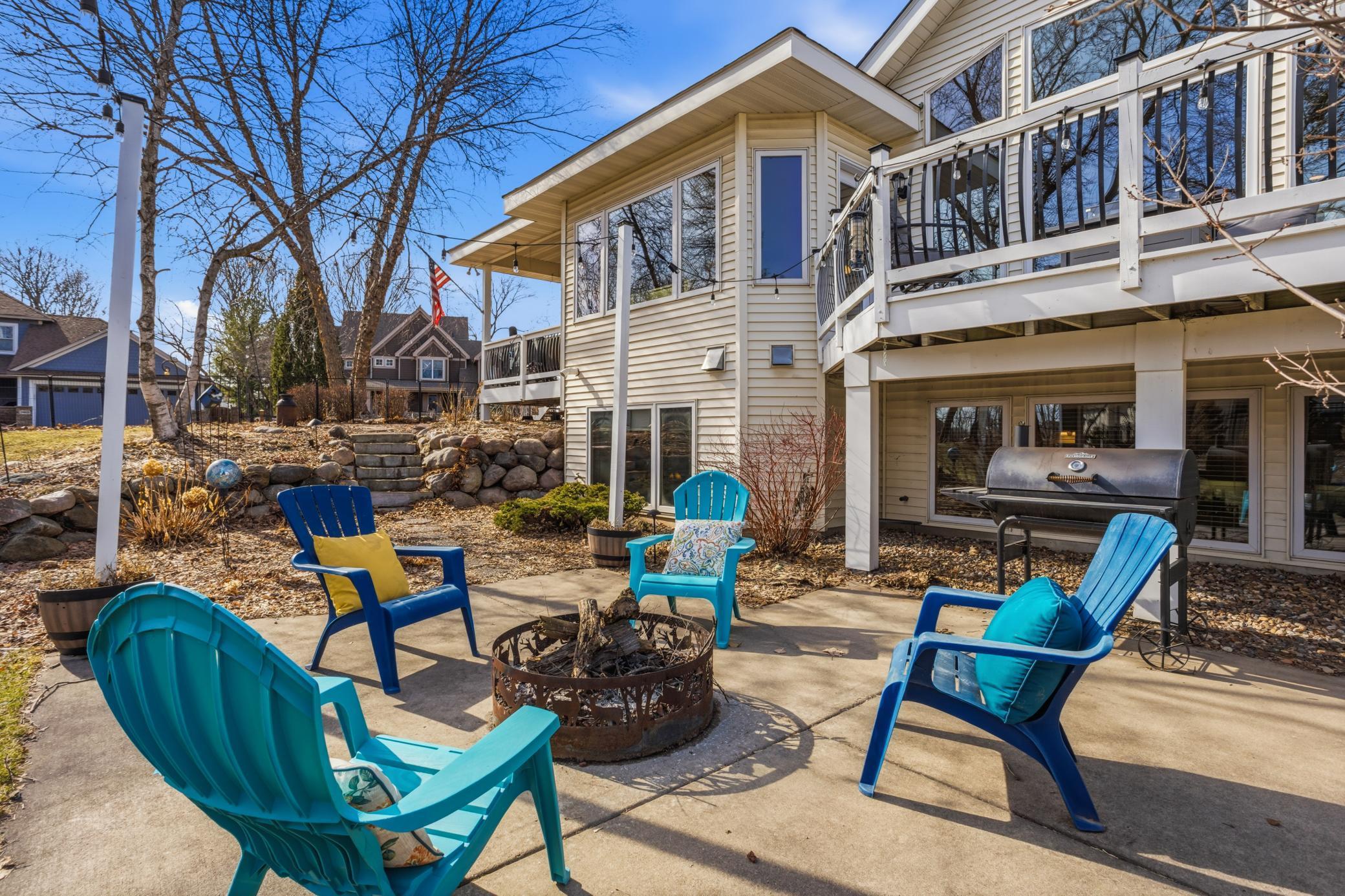 The paver firepit area creates a cozy setting for friends and family to gather. Perfect for roasting marshmallows, telling stories, or simply enjoying a relaxing evening under the stars.