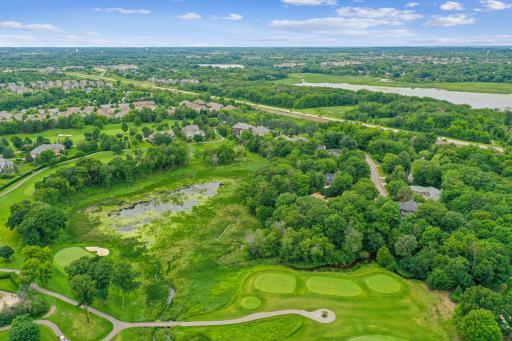 A serene, tree-lined Jack Nicklausâdesigned golf course nestled within a gated luxury community.