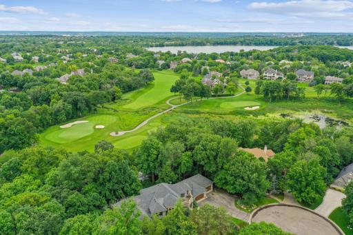 A serene, tree-lined Jack Nicklausâdesigned golf course nestled within a gated luxury community.