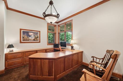 Stunning office with custom woodworkâwet bar just outside.