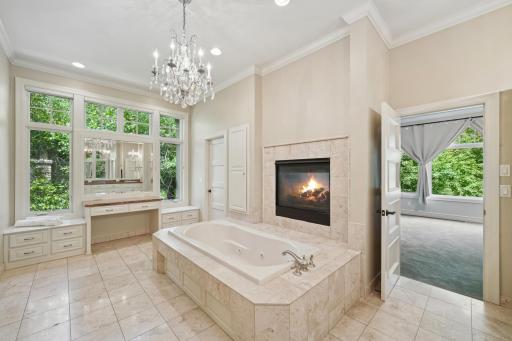 The main-level vaulted ownerâs suite offers a true escape with a two-sided fireplace, jetted tub, heated floors, and dual walk-in closets.