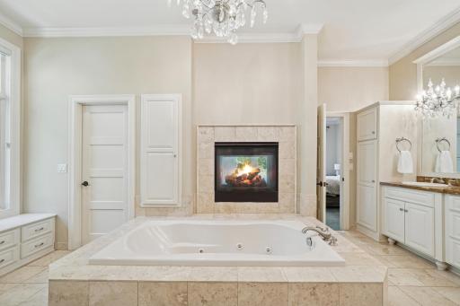 The main-level vaulted ownerâs suite offers a true escape with a two-sided fireplace, jetted tub, heated floors, and dual walk-in closets.