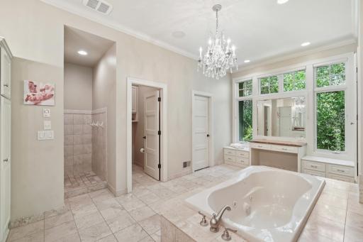 The main-level vaulted ownerâs suite offers a true escape with a two-sided fireplace, jetted tub, heated floors, and dual walk-in closets.