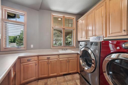 Spacious main-floor laundry with abundant storage.