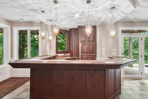 Walkout lower level with custom bar, wine cellar, and theater room.