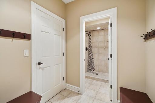 Outdoor access to hot tub + luxury bath with spa-like shower.