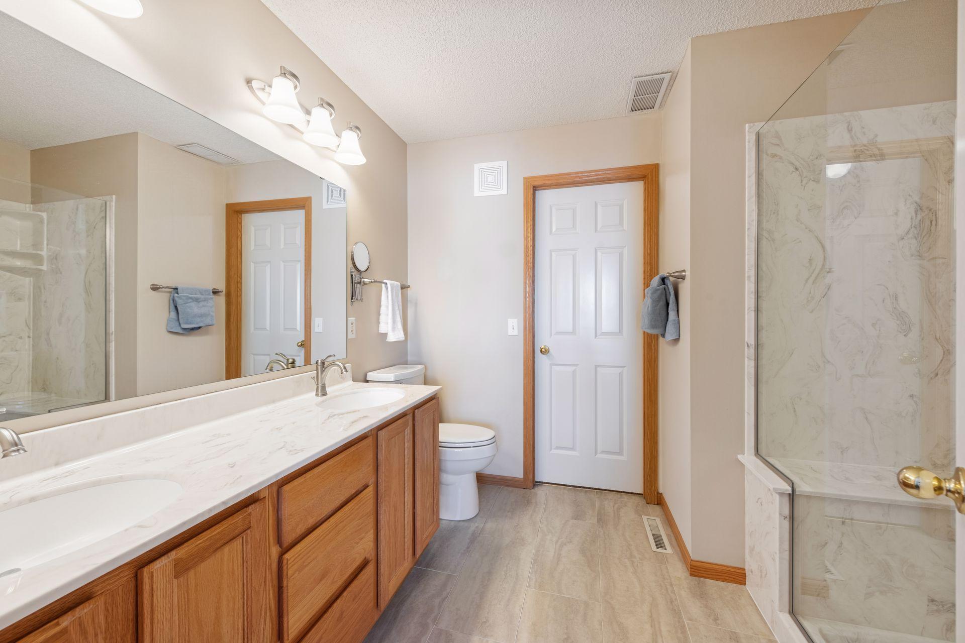 Updated private, primary bathroom with two sinks...