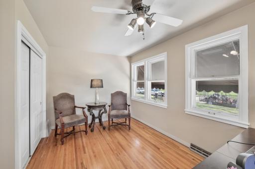 Bedroom 2, is currently being used as an office. Three windows to let the sunshine in, gleaming wood floors, closet and ceiling fan.