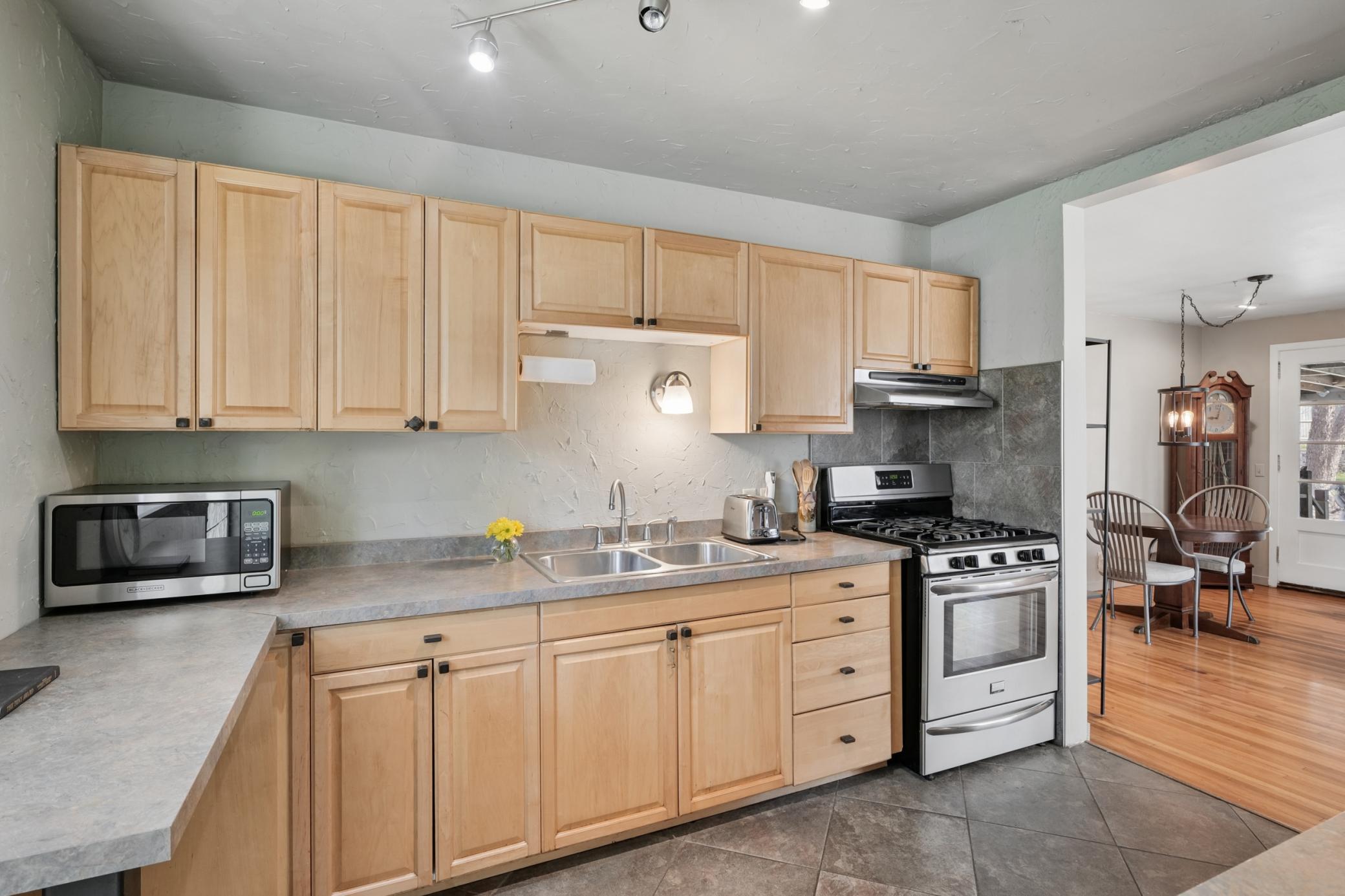 Heart of the Home, the kitchen boosts stainless steel appliances, heated stone floors, and garden window.