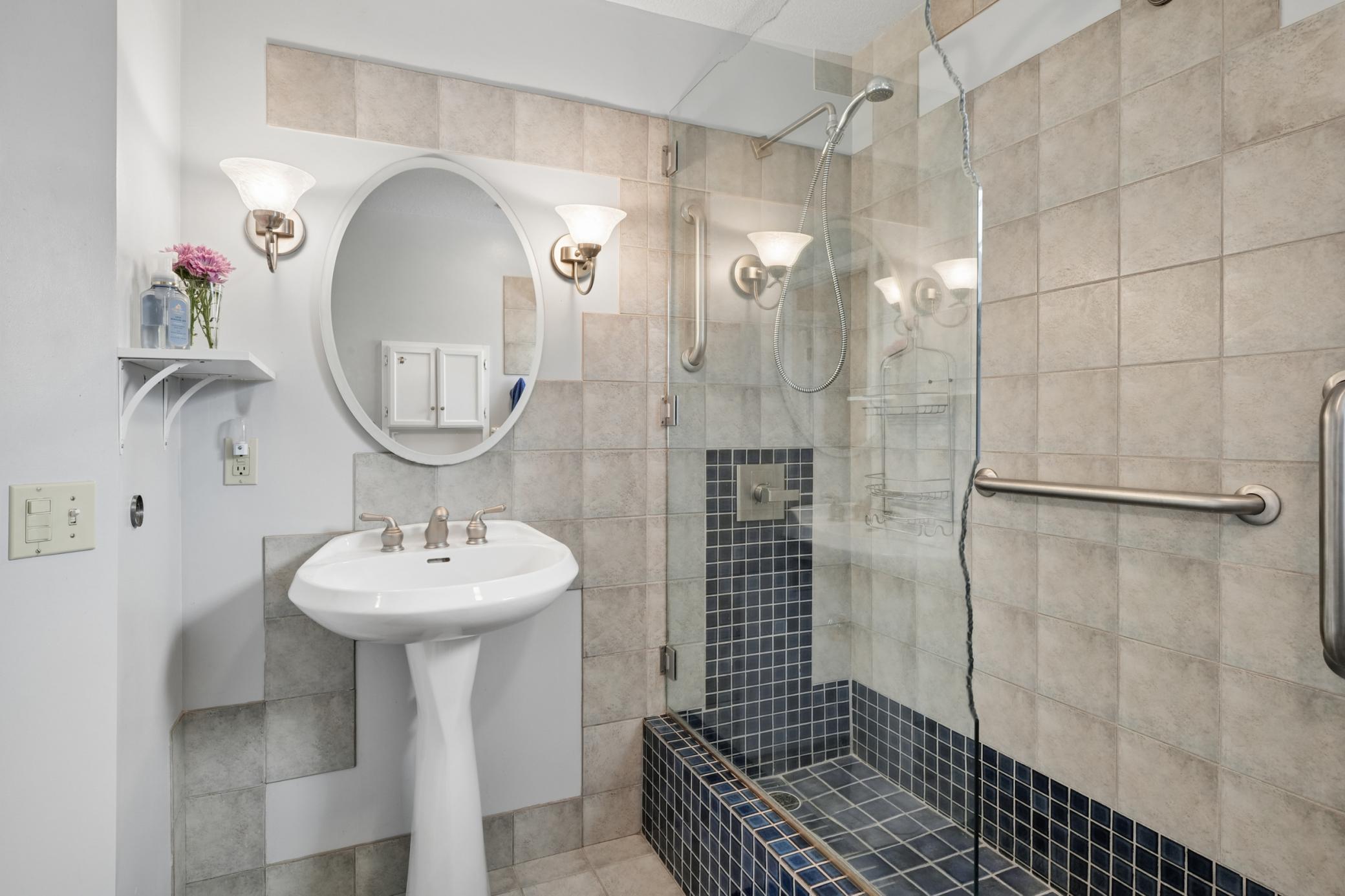 Main level bathroom, wake up to a beautiful, tiled floors, shower, pedestal sink, hooks to hang towels your clothes on.