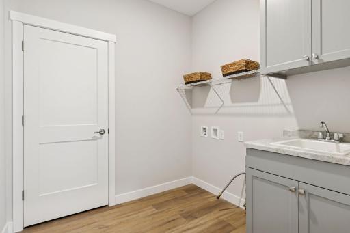 Laundry is complete with sink and storage