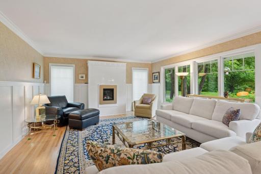 Renovated living room with new windows and gas fireplace, refinished hardwood floors and more.