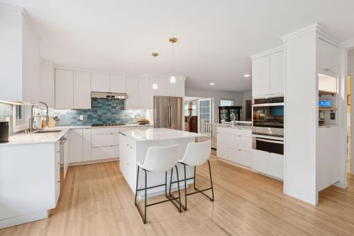 Kitchen custom renovations with new appliances and handmade tile backsplash