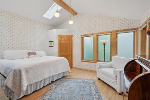 3rd main floor bedroom with vaulted ceiling and lots of windows.