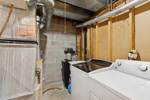 Laundry area with brand new water heater