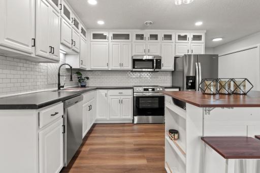 New center island, upper cabinets, sink, countertops, backsplash and more!