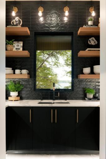Butler pantry complete with sink and double wall ovens - previously built home