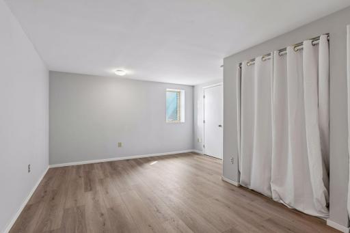 Lower level with newly installed egress window & flooring. There's a spacious cedar closet next to the egress window