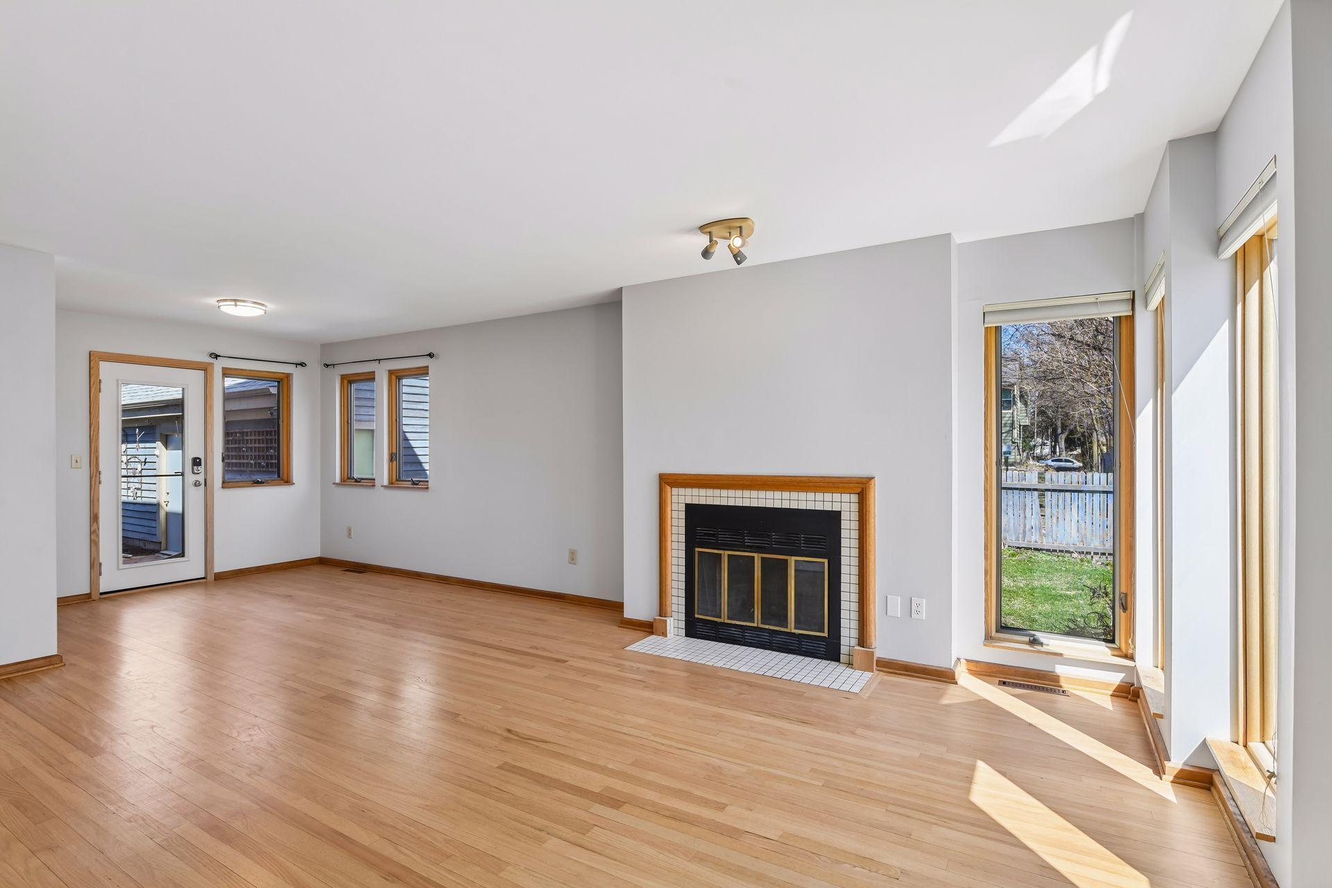 Open concept living and dining area with wood burning fireplace