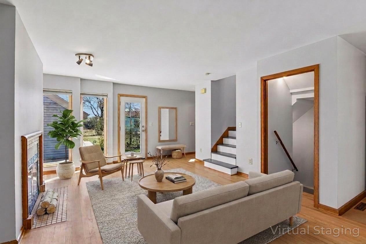 Sunny open living room with walk-out to side patio area - virtually staged