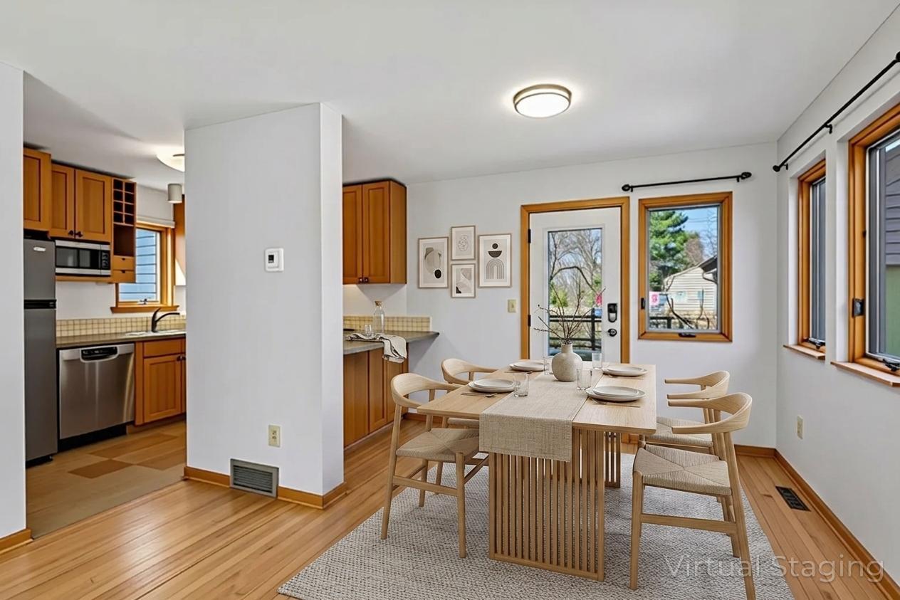 Dining area is open to living room & kitchen- virtually staged