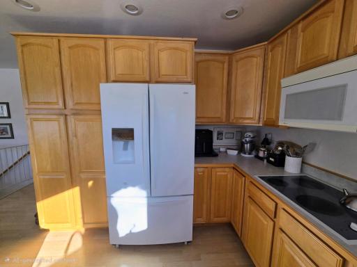 Kitchen features plenty of cabinets and countertops.