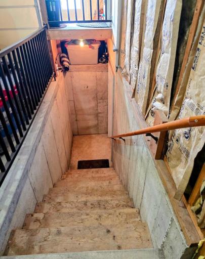 Garage steps that run to storage room in basement