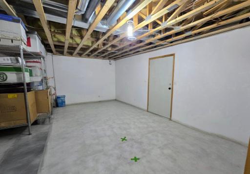 Storage room has door that leads to garage