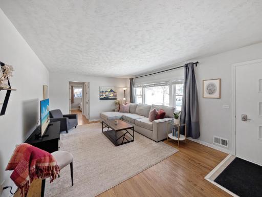 Picture window welcomes sunlight into this spacious living room!